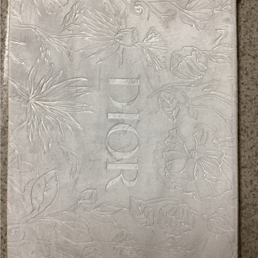 Dior white embossed make up bag.